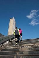 young  couple jogging on steps photo