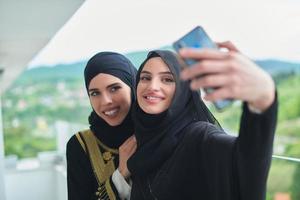 Portrait of young muslim women taking selfie on the balcony photo