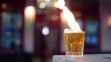 a glass of whiskey . burning strong alcoholic beverage video