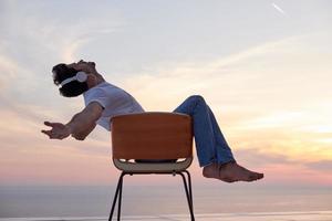 relaxed young man at home on balcony photo