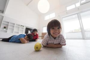 boys having fun with an apple on the floor photo