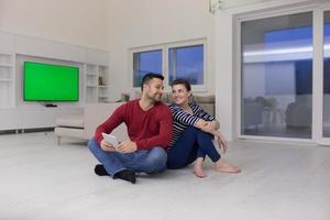 Young Couple using digital tablet on the floor photo