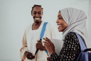 Group of happy african students having conversation and team meeting working together on homework girls wearing traidiional sudan muslim hijab fashion photo