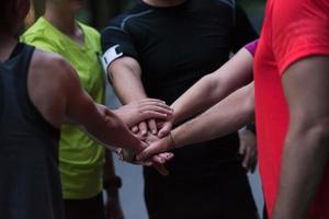 runners giving high five to each other photo