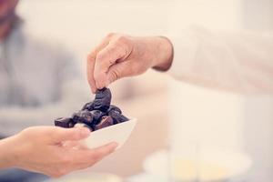 modern multiethnic muslim family sharing a bowl of dates photo