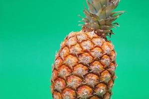 ananas on green background photo