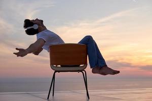 relaxed young man at home on balcony photo