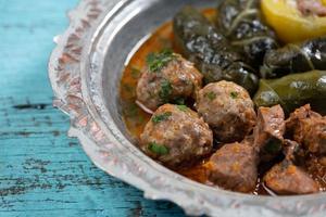 Eid Mubarak Traditional Ramadan Iftar dinner. Assorted tasty food in authentic rustic dishes on wooden table background. photo