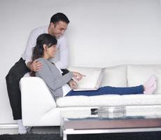 joyful couple relax and work on laptop computer at modern home photo