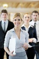 business woman standing with her staff at conference photo