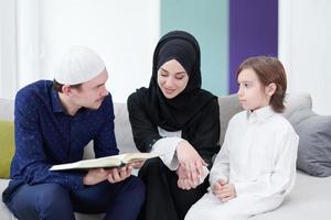 muslim family reading Quran and praying at home photo