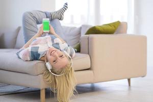 girl enjoying music through headphones photo