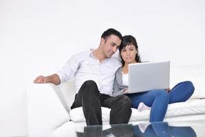 joyful couple relax and work on laptop computer at modern home photo