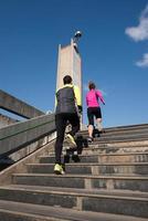 young  couple jogging on steps photo