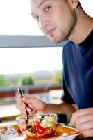 man eating healthy food it an restaurant photo