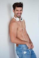 handsome young man listening music on headphones photo