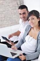 joyful couple relax and work on laptop computer at modern home photo