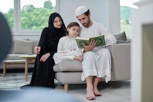 Young muslim family reading Quran during Ramadan photo