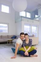 couple sitting on the floor at home photo