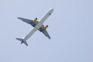 commercial aircraft flying under blue skies and arriving at the airport photo