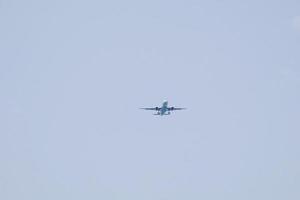 commercial aircraft flying under blue skies and arriving at the airport photo