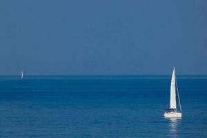 Solitary sailboat on the mediterranean coast of the Catalan Costa Brava photo