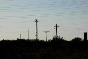 metallic electric towers supporting copper cables for transporting electricity photo