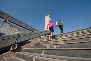 young  couple jogging on steps photo