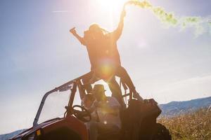 group of young people having fun while driving a off road buggy car photo