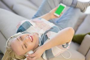 girl enjoying music through headphones photo