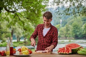 man cooking tasty food for french dinner party photo