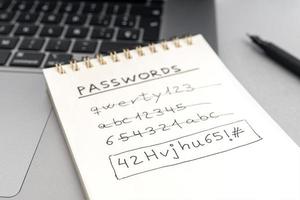 Strong computer security password concept. Changing a weak easy Password for a strong one. Handwritten text on notepad on laptop photo