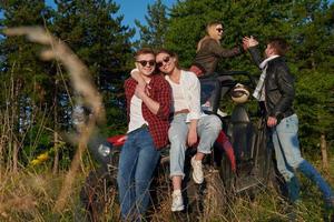 group young happy people enjoying beautiful sunny day while driving a off road buggy car photo