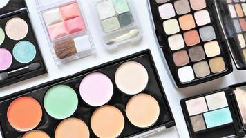 Collection of various cosmetic products. Make up eyeshadow palettes. photo