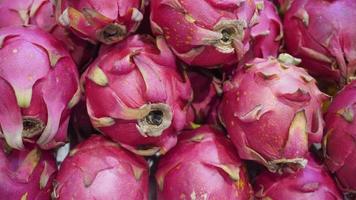 Stack of fresh dragon fruit for sale in a farmers market photo