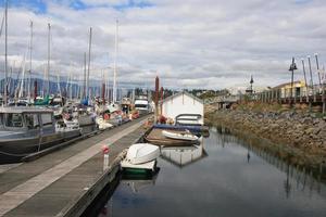 A boat marina with the harbour masters building in the background. photo