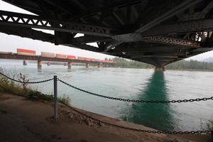 A shot of a railway bridge shot under another bridge. photo