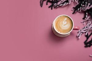 Autumn flat lay banner with cup of coffee latte and plaid on pink background. Creative autumn, thanksgiving, fall concept. Top view, copy space photo