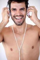 handsome young man listening music on headphones photo