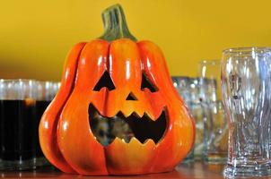 helloween party pumpkin and wine glasses close up photo
