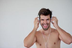 handsome young man listening music on headphones photo