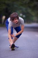 woman  stretching before morning jogging photo