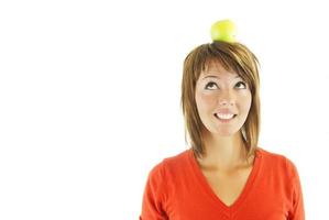 pretty girl with apple on head photo