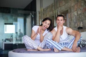 couple relax and have fun in bed photo