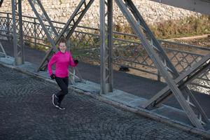 sporty woman jogging on morning photo