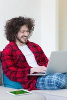 man freelancer in bathrobe working from home photo