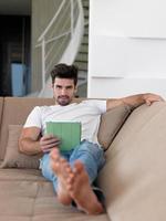 man using tablet computer from home photo