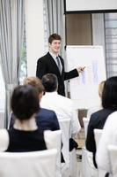 Young  business man giving a presentation on conference photo