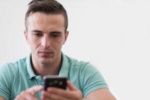 young man using a mobile phone  at home photo