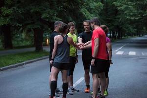 runners giving high five to each other photo